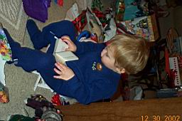 DCP_2325-Tyler-book reading on mini-chair.JPG